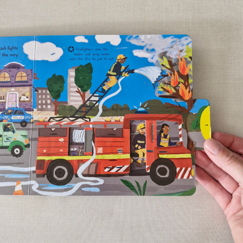 Children's book with a fire truck illustration on a beige surface