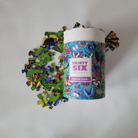 Crocodile Creek Puzzle tube with puzzle pieces on a white background