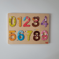 Wooden numbers puzzle with colorful designs on a light grey background