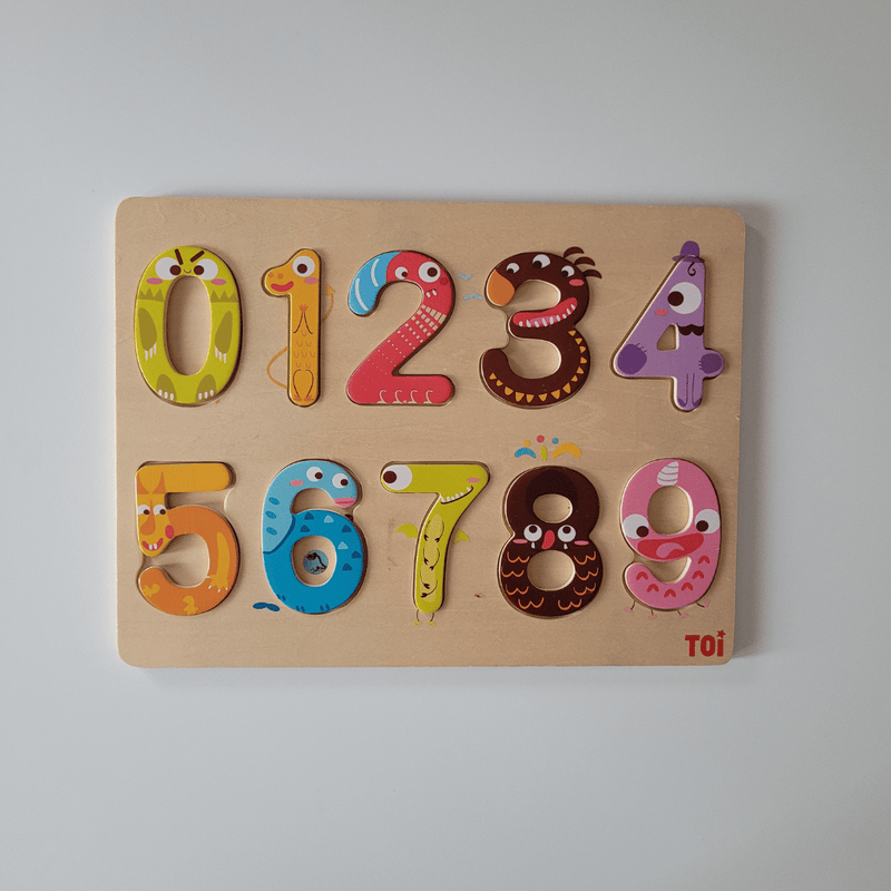 Wooden numbers puzzle with colorful designs on a light grey background