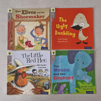 Four children's books with colourful covers on a grey background