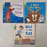 Three children's books on a textured surface