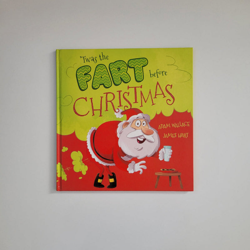A children's hardcover book titled 'Twas the Party Before Christmas' by Adam Wallace, featuring a festive red and yellow cover with a cartoon illustration of Santa Claus, photographed against a neutral light gray background.