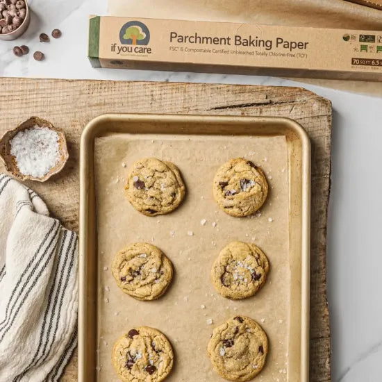 Baking tray with cookies on parchment paper, next to a box of if you care parchment baking paper.