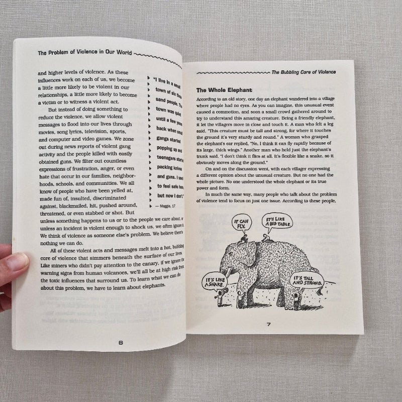 Open book with text and a black and white illustration on a gray background