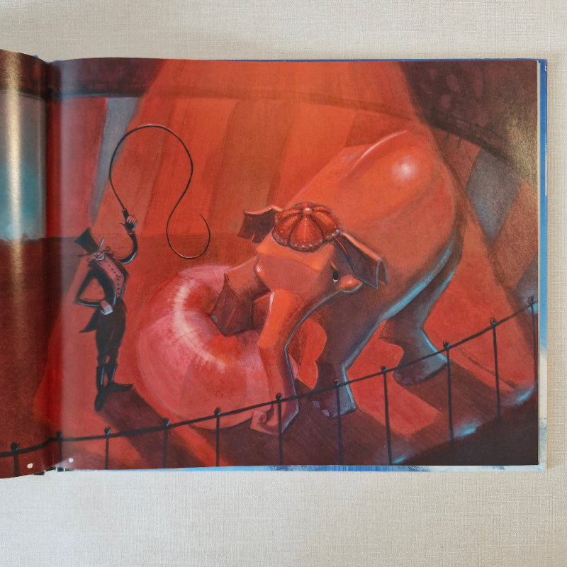 Book page with elephant in circus ring standing on a ball