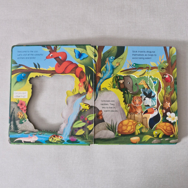 Colourful children's zoo book with animal illustrations on a light gray background