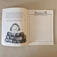 Open book with illustrations of a woman and apples on a beige fabric background