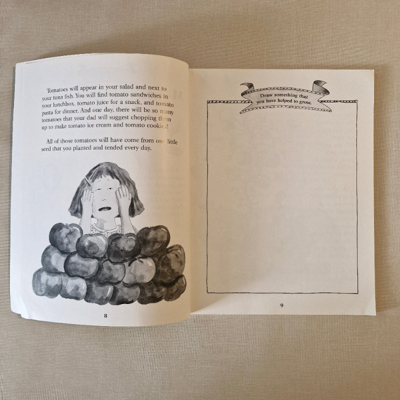 Open book with illustrations of a woman and apples on a beige fabric background