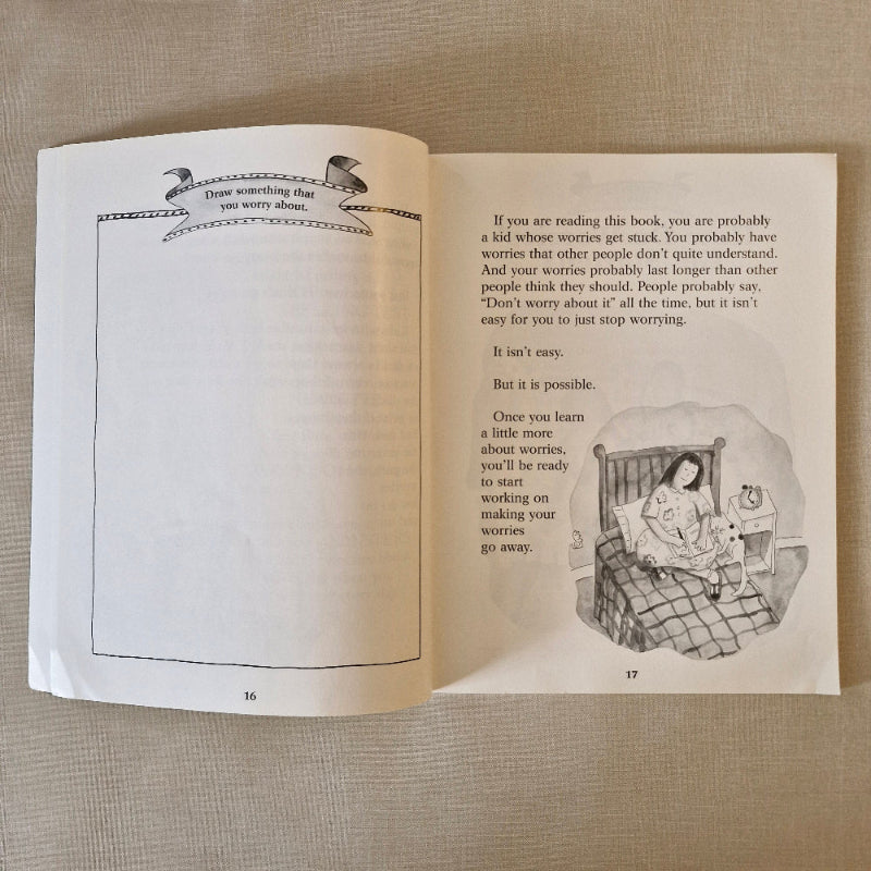 Open book with illustrations and text on a textured surface