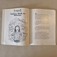 Open book with a illustration and text on a beige fabric background