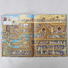 Illustrated book open to a detailed picture of a egypt tombs with various rooms and characters on a grey background.