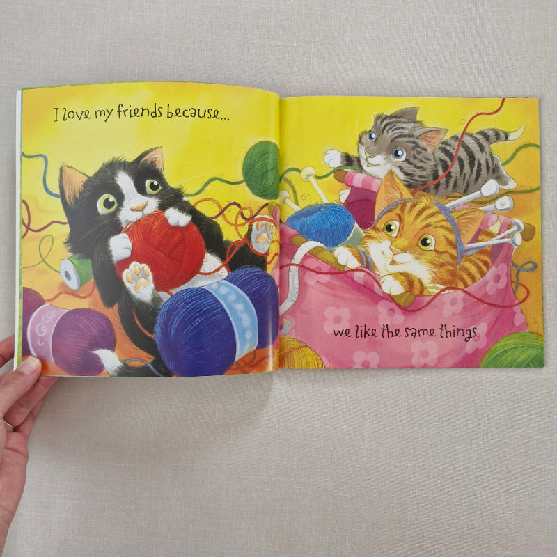 Colourful children's book with cat illustrations on a plain background