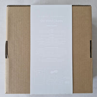 Cardboard box with a white label on a grey background