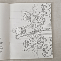 Colouring book page with a black and white illustration of shepherds and sheep on a textured surface.