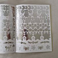 Sheet of Wizard-themed silver stickers on a gray surface