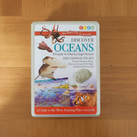 Educational kit packaging for 'Discover Oceans' on a wooden surface