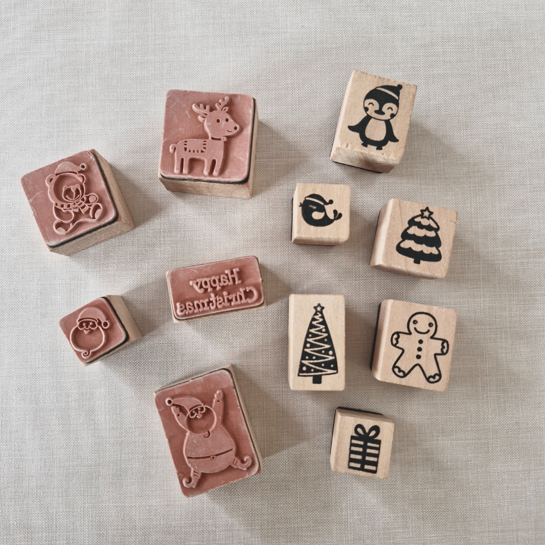 Set of wooden stamps with various designs on a textured surface