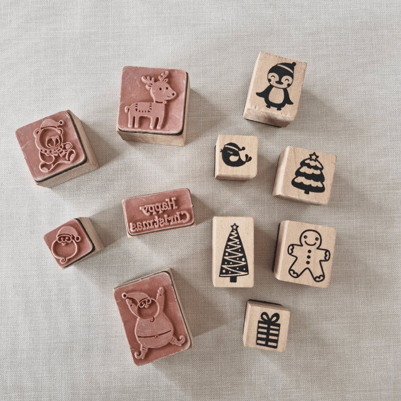 Set of wooden stamps with various designs on a textured surface