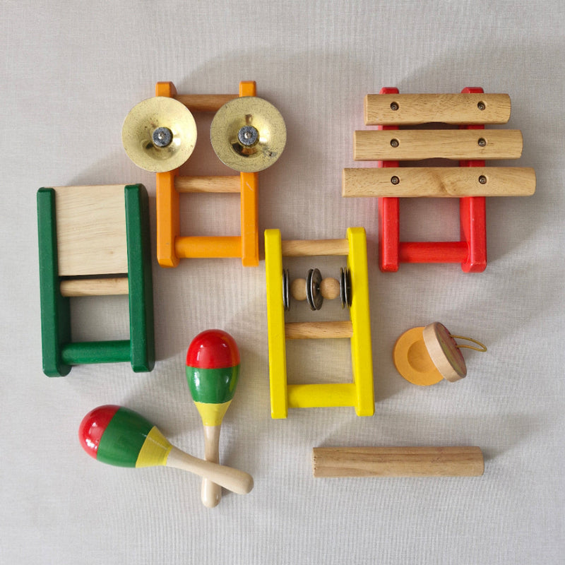 Colourful wooden toy set on a light grey background