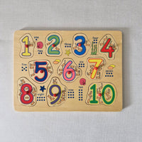 Wooden number puzzle with colourful numbers and animal illustrations on a light gray background