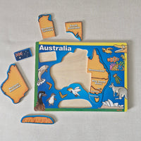 Educational puzzle with Australia map and state shapes on a gray background