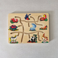 Wooden puzzle with colourful animal illustrations on a beige background