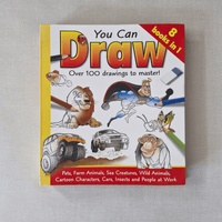 Book titled 'You Can Draw' with illustrations on a grey background
