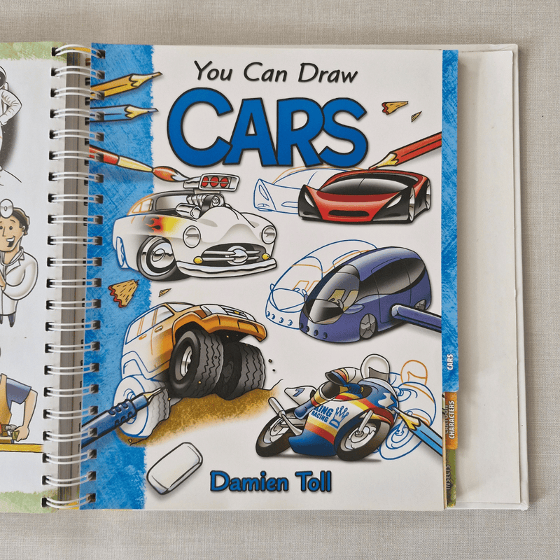 Book titled 'You Can Draw Cars' by Damien Toll with illustrations of cars on the cover.