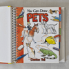 Book titled 'You Can Draw Pets' by Damien Toll on a grey background