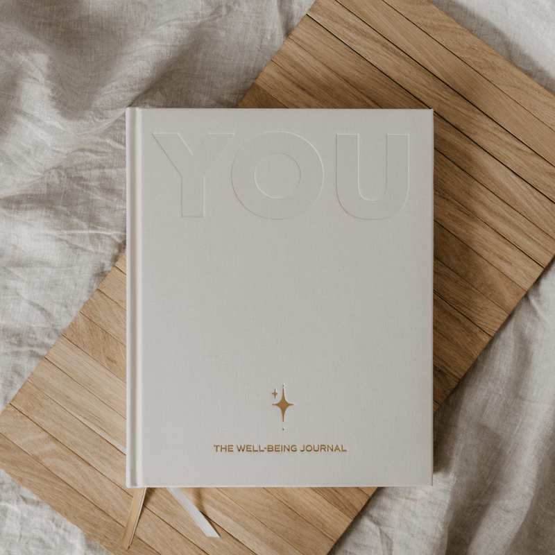 Well-being journal titled 'You' on a wooden surface