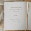 Open book with motivational quote on a wooden surface