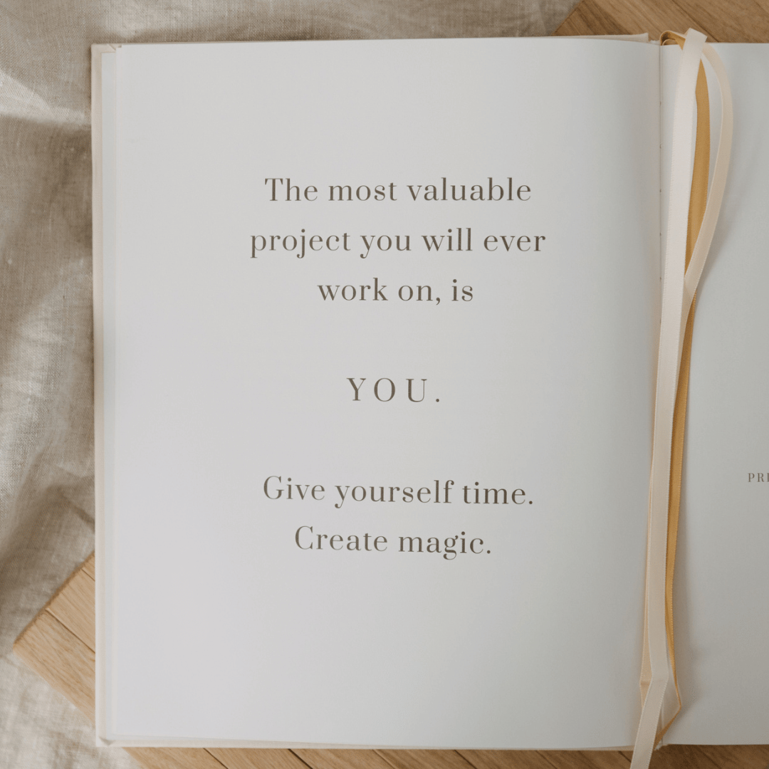 Open book with motivational quote on a wooden surface