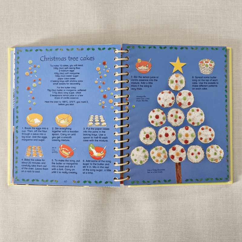 Open book with a recipe for Christmas tree-shaped cakes on a textured surface