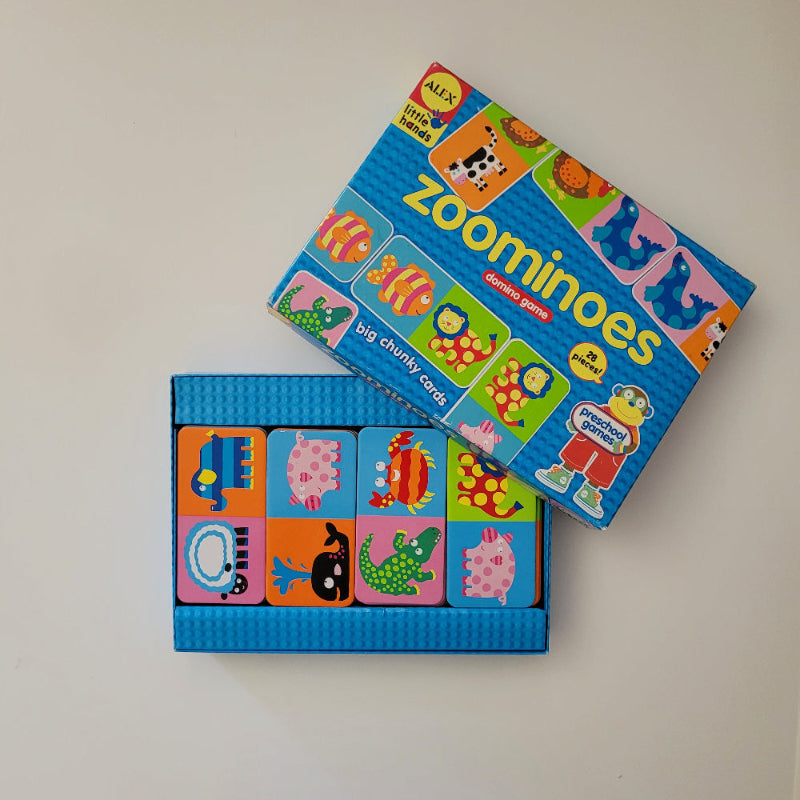 Zoominoes children's educational toy with colourful animal illustrations on a beige background