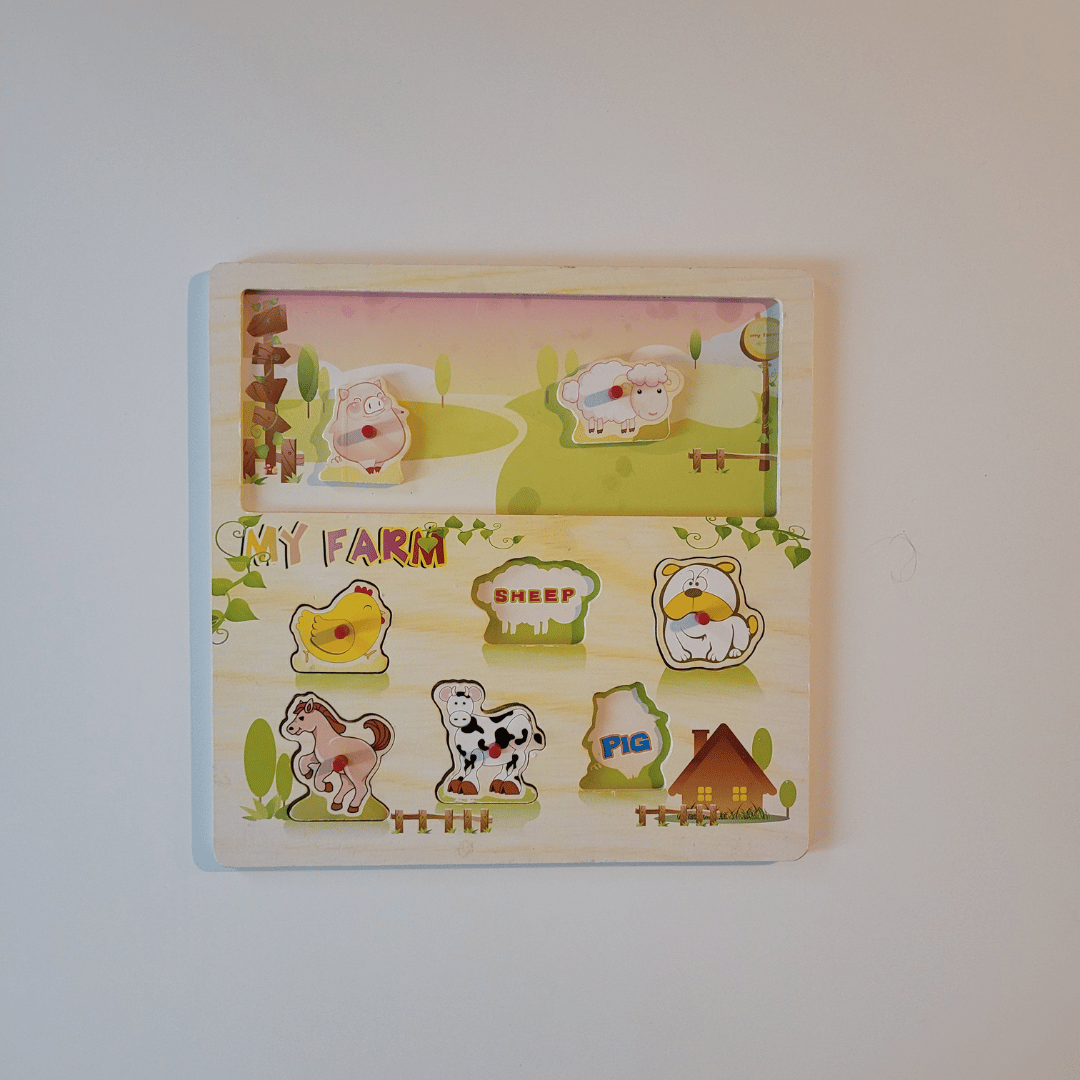 Children's educational puzzle with farm animals on a plain background