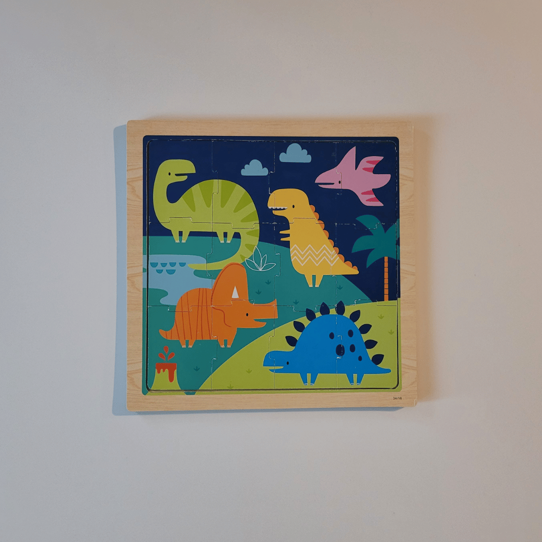 Children's wooden puzzle with colorful dinosaur illustrations on a plain background