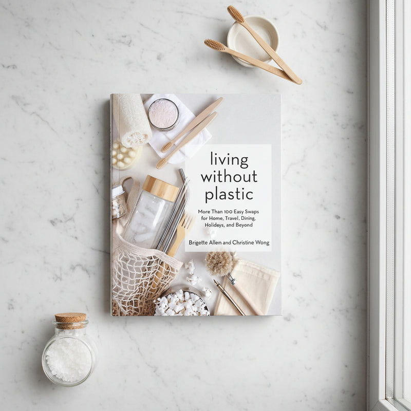 Book titled 'living without plastic' sitting on marble benchtop
