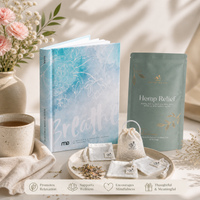 Book titled 'Breathe' with a bag of tea labeled 'Hemp Relief' on a table with flowers and tea and reusable tea bags