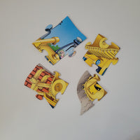 Four puzzle pieces of a bulldozer on a white background