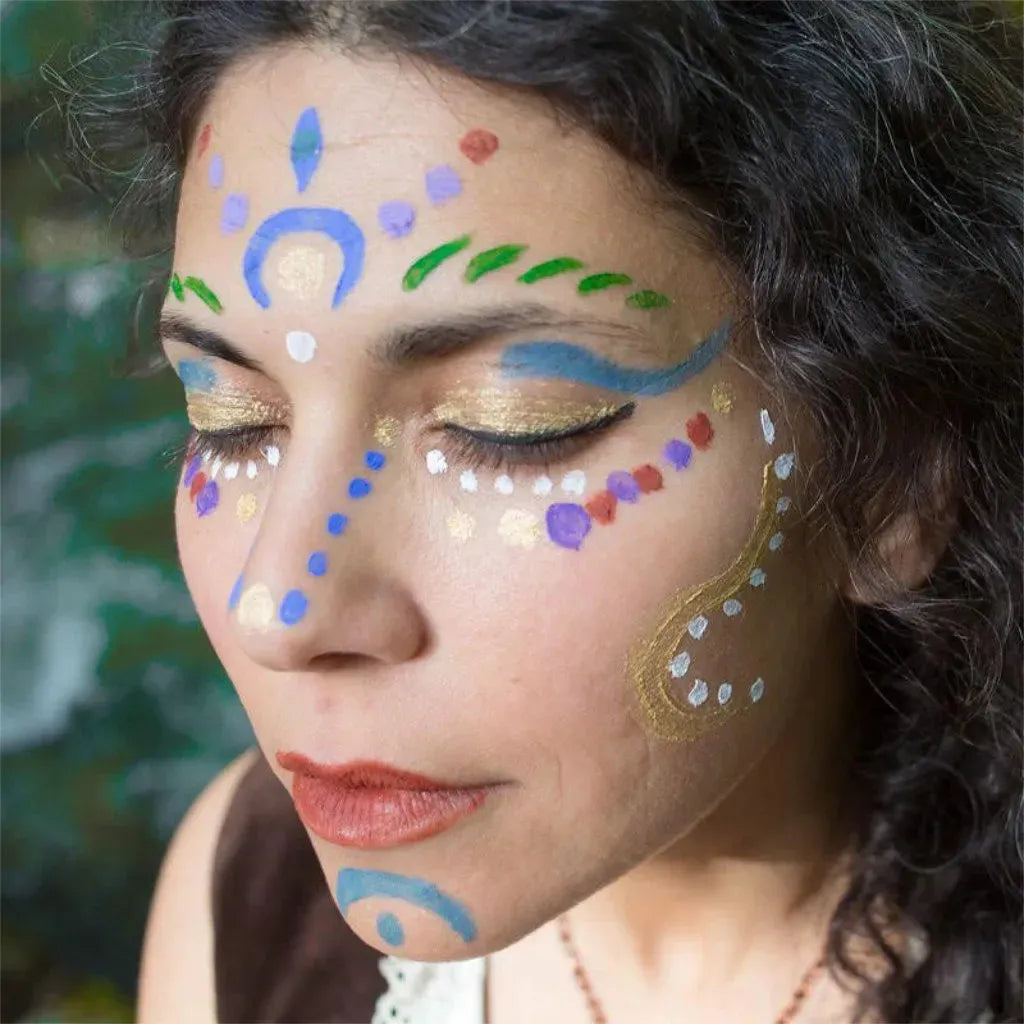 Woman with colourful face paint against a blurred natural background