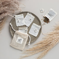 5 reusable Teabags on a tray with loose tealeaves