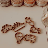 Transportation dough cutters on a white surface. Cars, boats, hot air balloon, truck