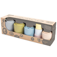 A set of Dantoy BioPlastic Stacking Cups in various natural colors, presented in a cardboard packaging with the brand and product information.